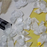 white ribbon bowknt with rose
